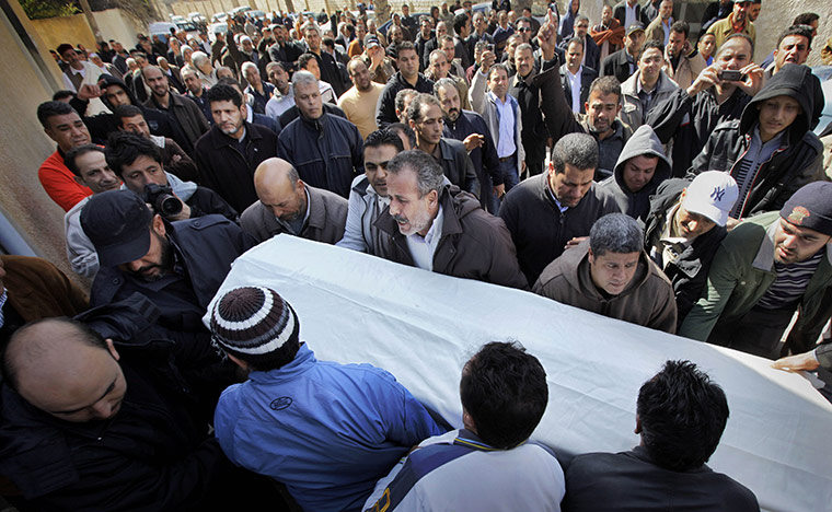 Libya 26 Feb: Mourners carry a coffin at a funeral in eastern Tripoli