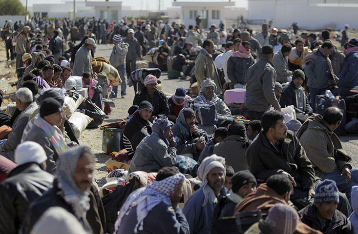 Libya 26 Feb: Egyptians who used to work in Libya wait at the Tunisia-Libya border