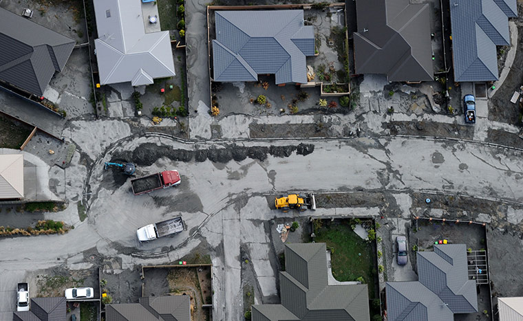 24 hours in pictures: A suburban street is cleared after the recent earthquake in Christchurch