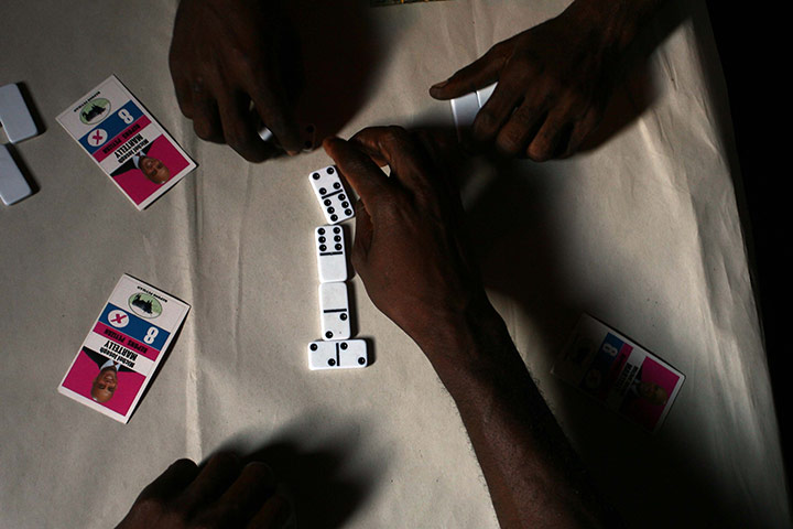 24 hours in pictures: A group of men  play dominoes in haiti