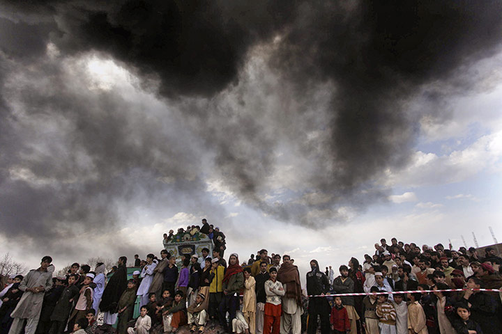 24 hours in pictures: People watch burning NATO fuel tankers after a bomb explosion in pakistan