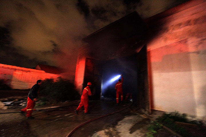 Libya: Firefighters extinguish a blaze at an abandoned army barracks in Benghazi 