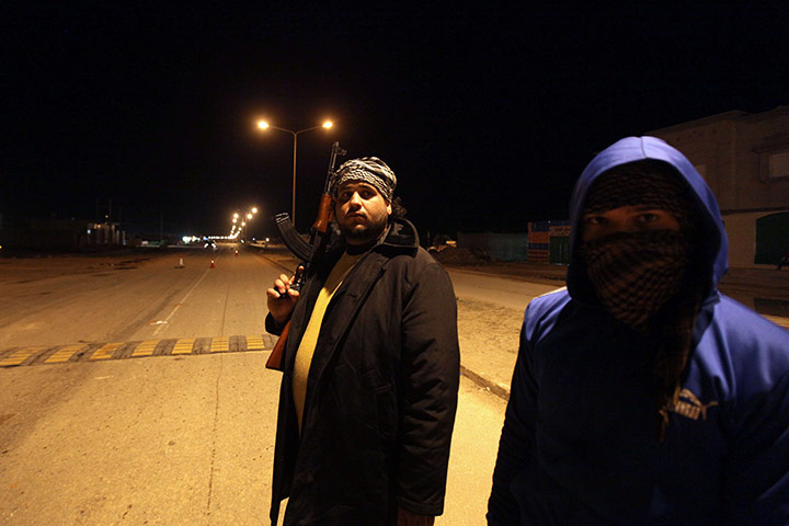 Libya: Rebel fighters patrol a street in Benghazi 