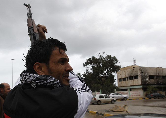 Libya: A gunman celebrates the freedom of the city of Benghazi by firing a gun into the air