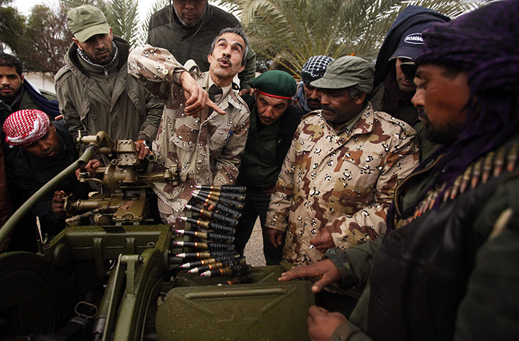 Libya unrest continues: A rebel army officer teaches the use of an anti-aircraft gun 
