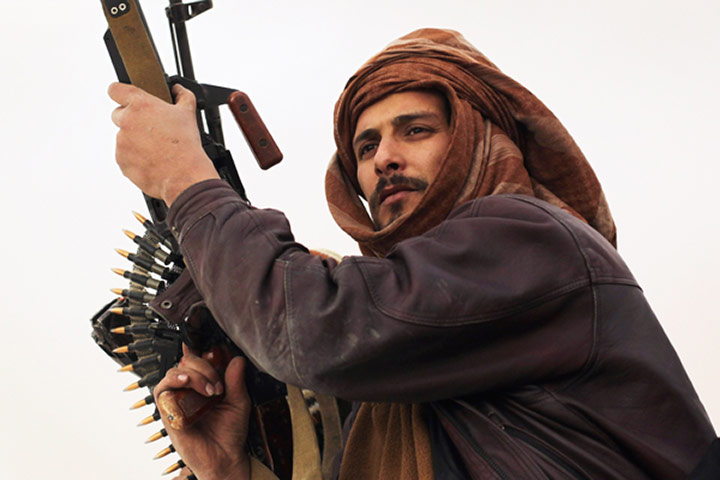 Libya unrest continues: A tribal rebel takes up position at a checkpoint in Ajdabiya.