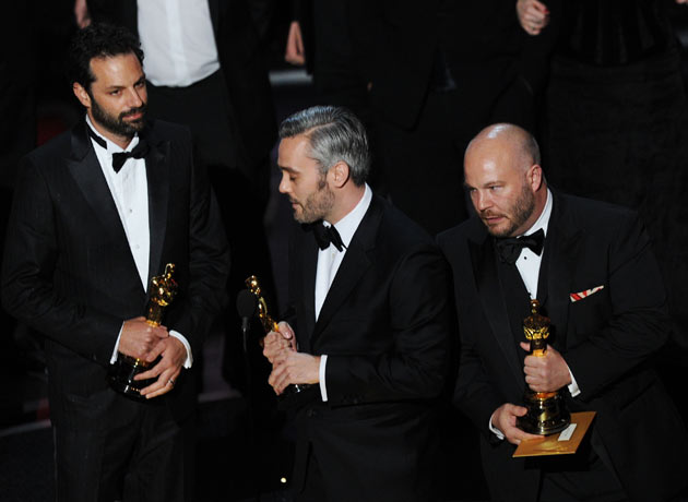 Producers Emile Sherman, Iain Canning and Gareth Unwin accept best film Oscar for The King's Speech