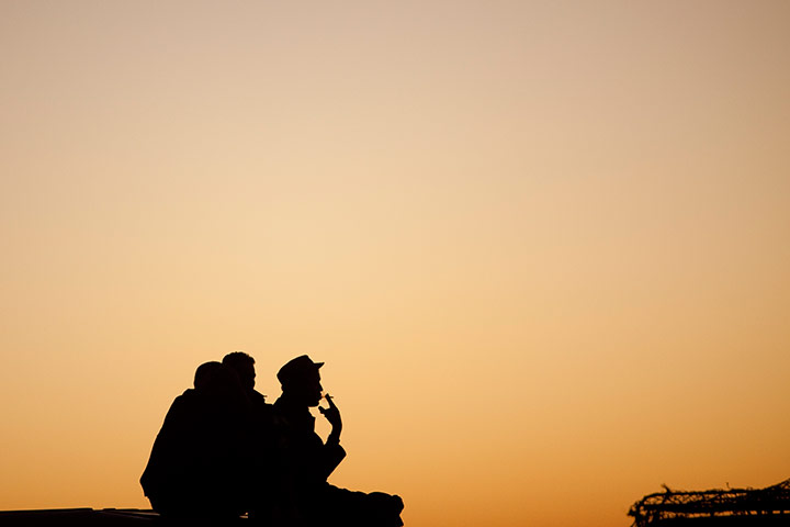 24 hours in pictures: Pro-independence Polisario Front rebel soldiers smoke on top of a jeep