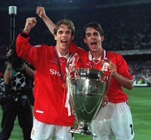 Gary Neville retires: Phil and Gary Neville celebrate after United win the Champions League