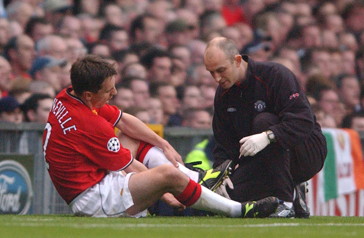 Gary Neville retires: Gary Neville receives treatment after breaking metatarsal