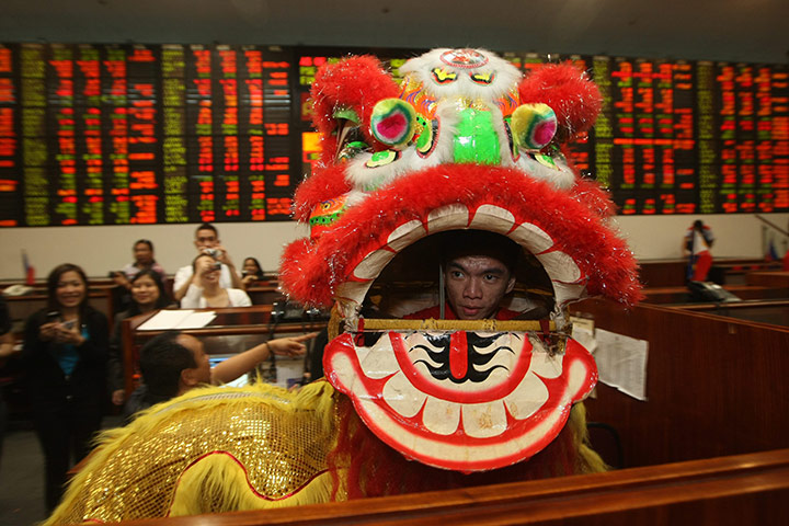 Chinese New Year: A Filipino performs a lion dance at the Philippine Stock Exchange