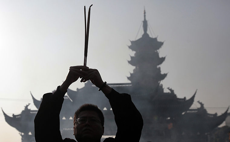 Chinese New Year: A worshipper offers the first prayer of the lunar new year