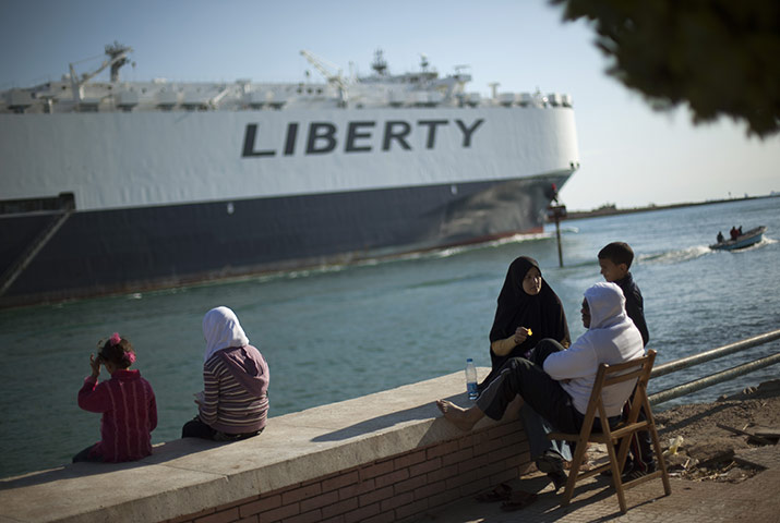 Week in Business: A cargo ship transits the Suez Canal en route from the Mediterranean Sea