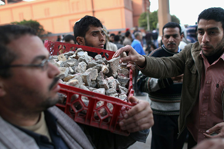 24 hours in pictures: Anti-government protesters bring stones to throw during clashes in Egypt