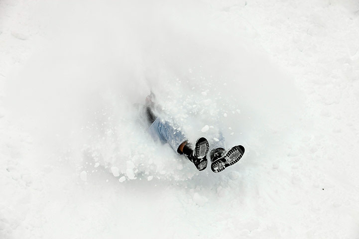 24 hours in pictures: Man sleighs down snow covered hilll in Iowa