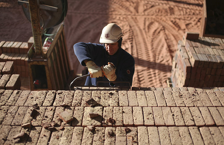 Week in Business: An employee removes bricks from a kiln at Michelmersh Brick Holdings 
