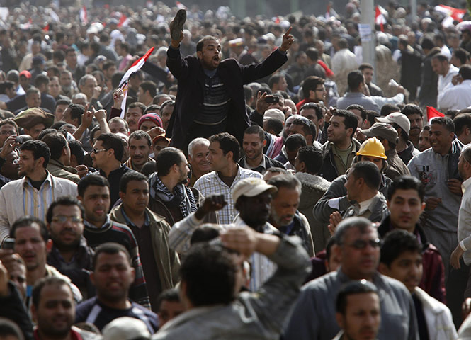 Egyptian Protests: An opposition supporter waves his shoe, a sign of disrespect