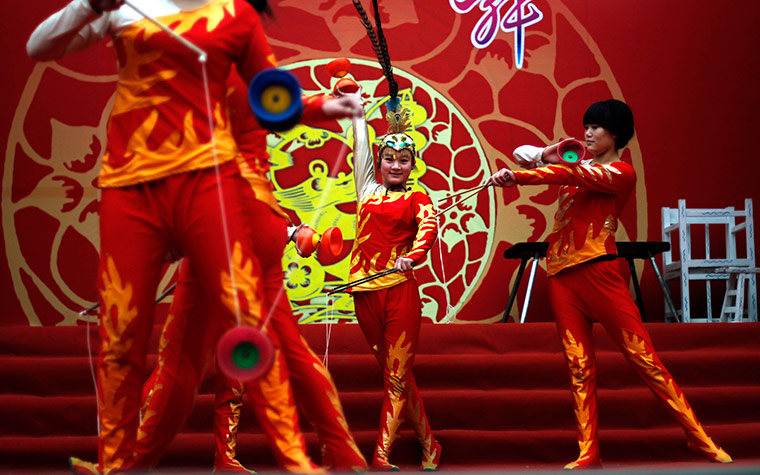 24 hours in pictures: Chinese girls perform at the Dongyue temple fair, Beijing