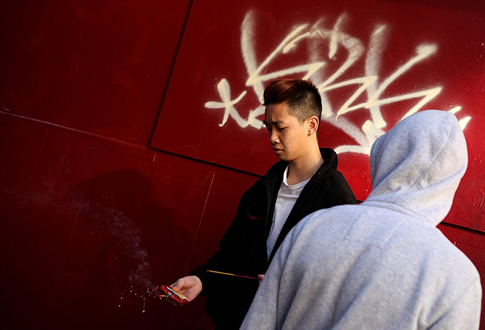 24 hours in pictures: Men light firecrackers as they celebrate Chinese New Year in San Francisco