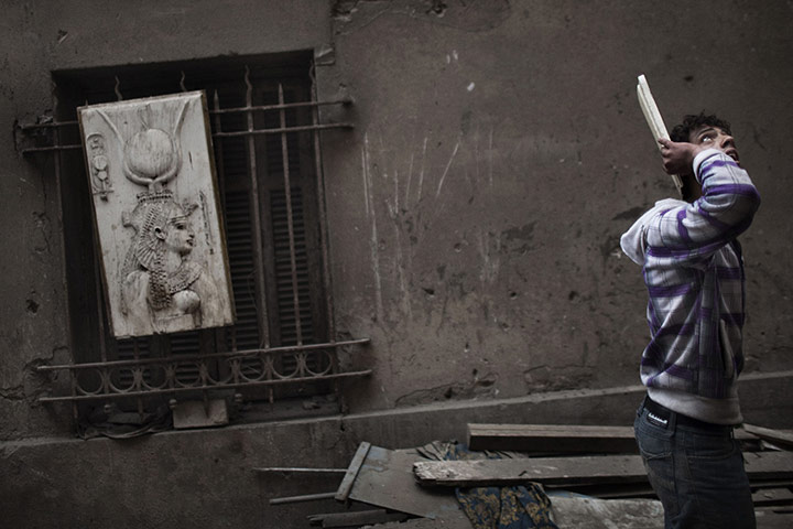 24 hours in pictures: An anti-Egyptian government demonstrator looks up during violent clashes