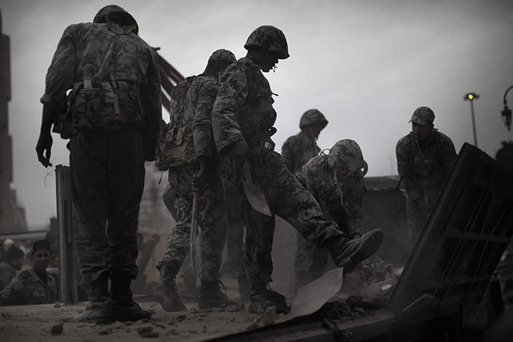 Egypt 05/02: Egyptian soldiers remove stones from a truck used as a barricade 