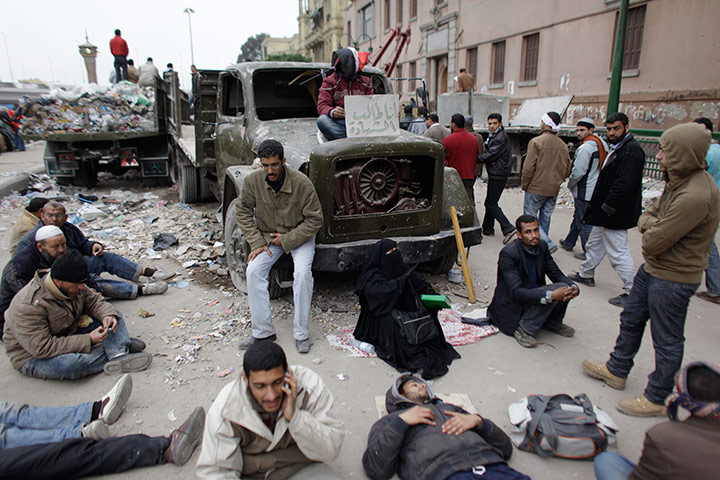 Egypt 05/02: A protestor holds a poster reading 'Ready to be a martyr', in Tahrir Square