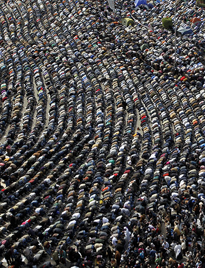24 Hours: Anti-govermnent demonstrators pray in Tahrir Square, Cairo