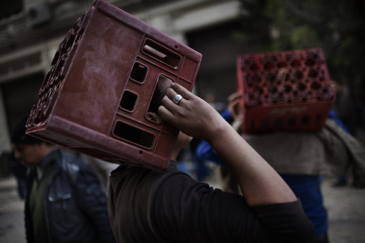 24 Hours: Egyptian anti-government protestors hold craters to protect themselves