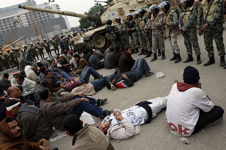 Egypt 05/02: Egyptian anti-government demonstrators face soldiers in Tahrir Square