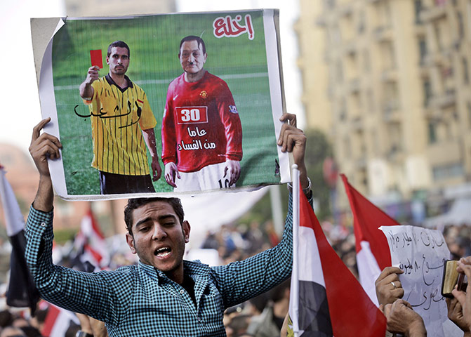 Egypt protests day 13: Placard depicting President Mubarak as football player receiving a red card