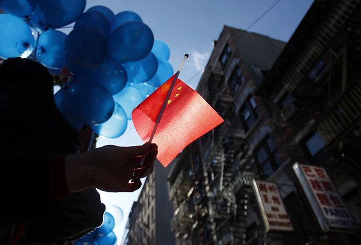 24 hours: New York, USA: A spectator holds a Chinese national flag