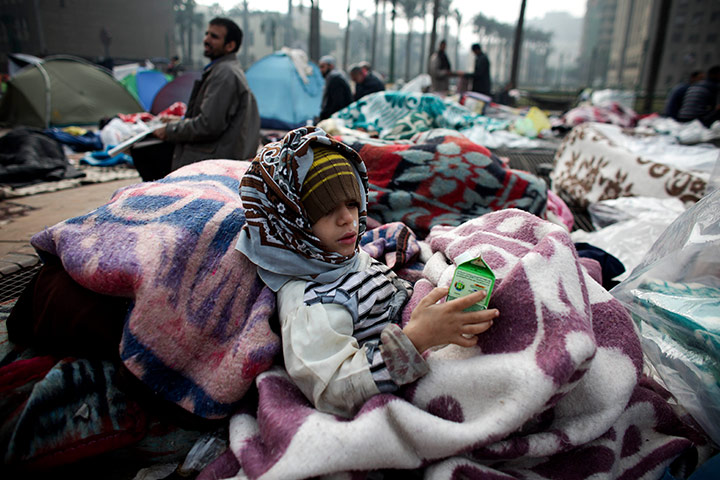 Egypt day 14: An Egyptian girl drinks milk after sleeping in Tahrir Square