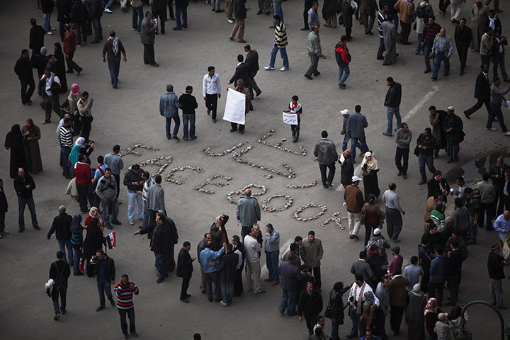 Egypt day 14: Anti-government protesters take pictures of protest art in Tahrir Square