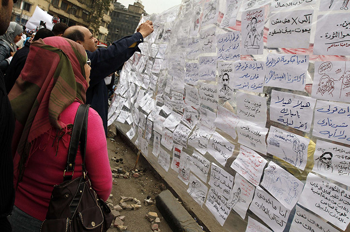 Egypt day 14 update: Anti-Mubarak slogans are hung on a makeshift-wall at Cairo's Tahrir square