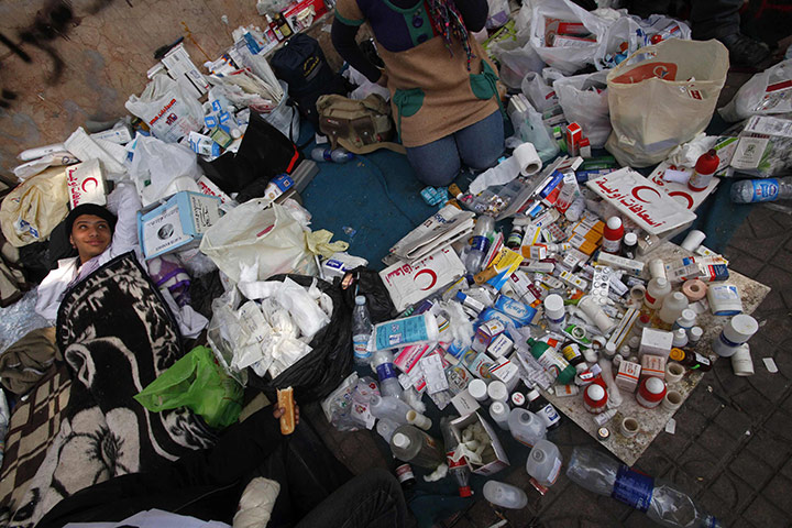 Egypt protests day 15: A man rests amid medical supplies in Tahrir Square 