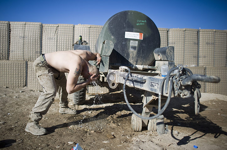 24 hours in pictures: A US Marine from Bravo company washes his head, Afghanistan
