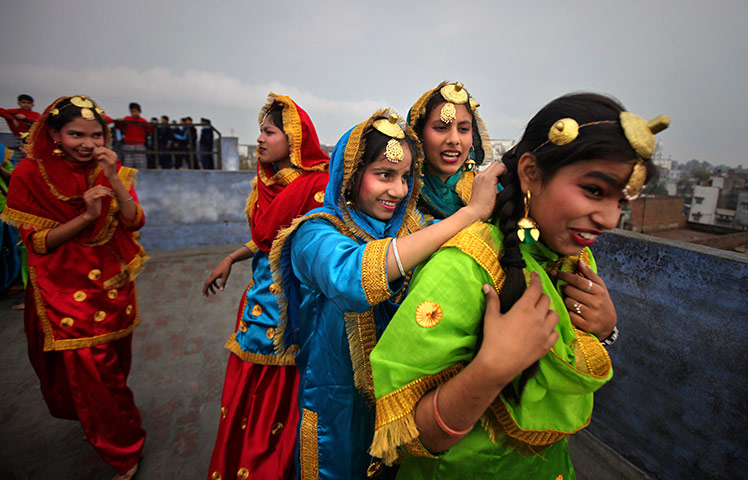 24 hours in pictures: Indian school girls wearing traditional attire
