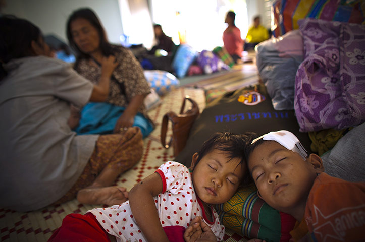 24 hours in pictures: Thai villagers rest in shelters after fleeing the border