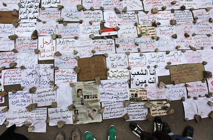 24 hours in pictures: Demonstrators look at a makeshift museum of protest messages, Egypt