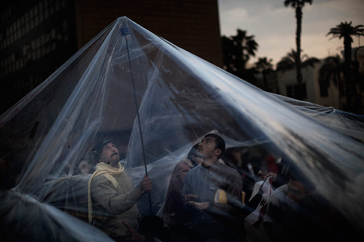 24 hours in pictures: Protestors arrange transparent plastic sheets for shelter, Egypt