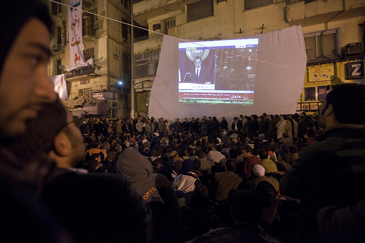 sean smith in egypt: Protestors in Tahrir Square watch President Mubarak's televised speech