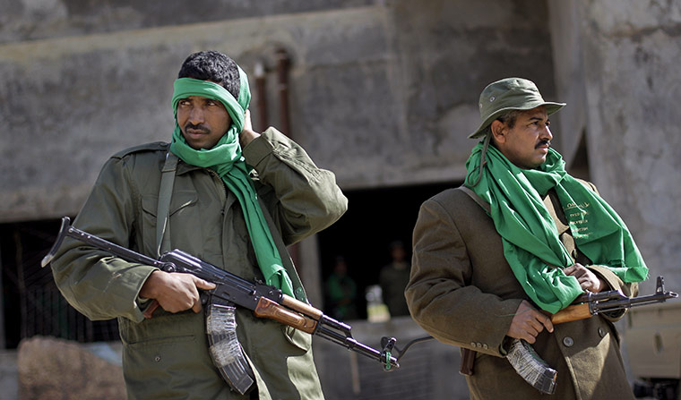 Libya: Pro-Gaddafi security forces stand near a checkpoint in Qasr Banashir