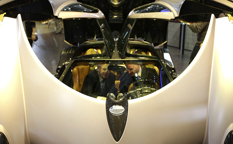 Geneva Motor Show: Visitors sit in the new Huayra sports car