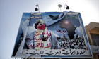 A vandalised billboard of Muammar Gaddafi in Benghazi on 1 March 2011.