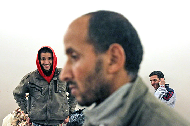 24 hours in pictures: Immigrants smile after the end of their six-week hunger strike in Athens