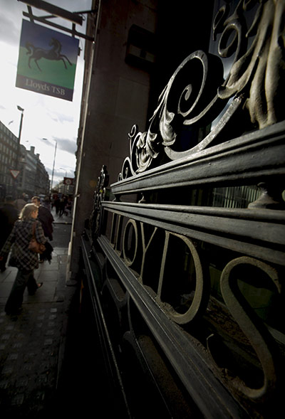 Week in business: Pedestrians walk past a branch of Lloyds TSB in London