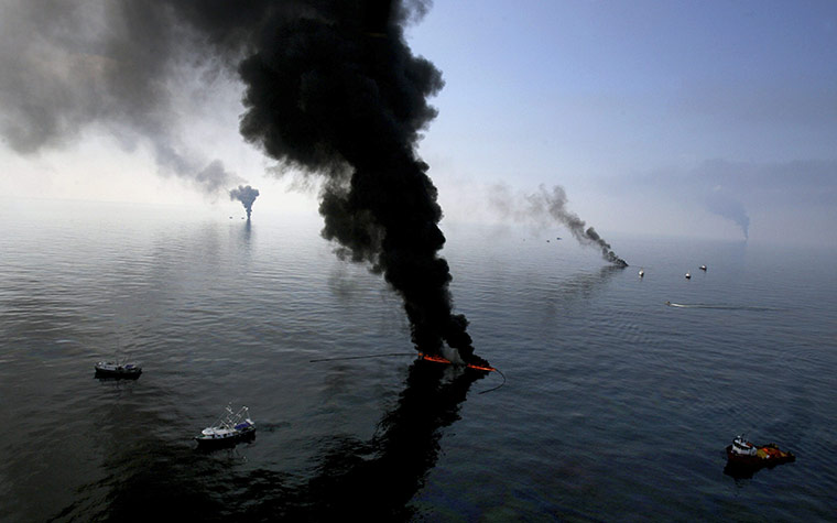 Week in business: Smoke billows from a controlled burn of spilled oil off the Louisiana coast