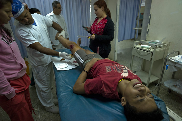 Venezuela Caracas : A fifteen year old boy receiving treatment to ashotgun wound Petare Caracas