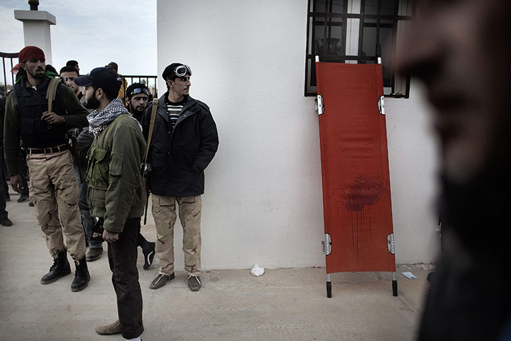 Ras Lanuf Update Libya: Libyan rebel fighters wait for news of wounded comrades