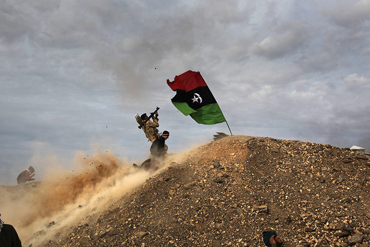 24 hours in pictures: Rebels fire a rocket-propelled grenade at a Libyan air force fighter jet